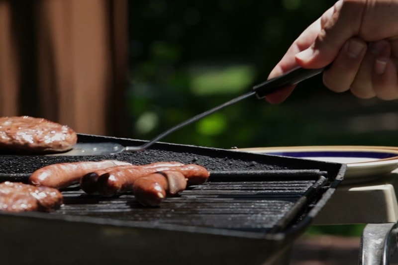 Person grilling outside in order to save energy